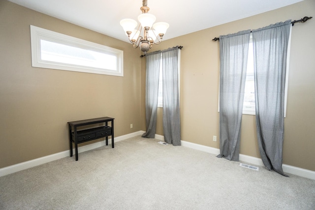 11474 Laketowne Dr, Albertville, MN 55301 - spare room featuring a chandelier, carpet flooring, and baseboards