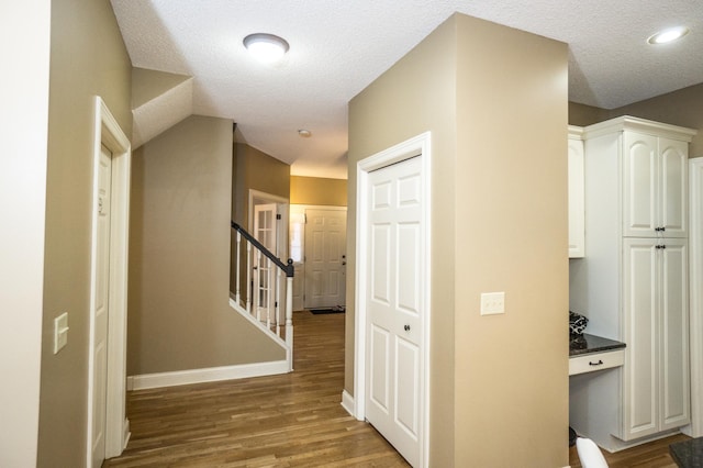 11474 Laketowne Dr, Albertville, MN 55301 - hall with wood finished floors, a textured ceiling, baseboards, and stairs