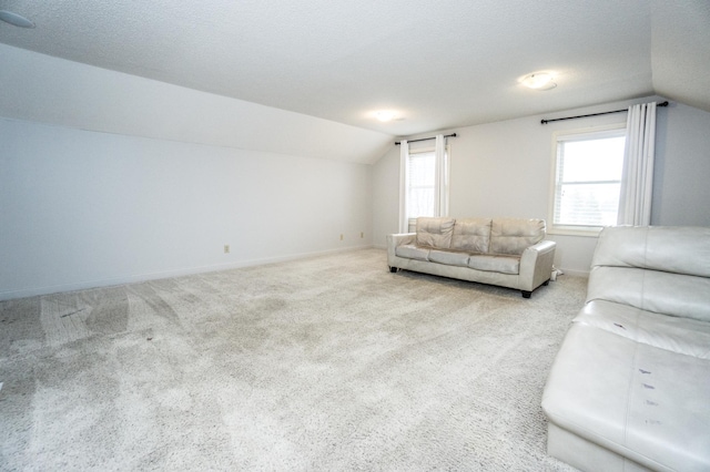 11474 Laketowne Dr, Albertville, MN 55301 - carpeted living area with lofted ceiling and baseboards