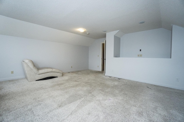 11474 Laketowne Dr, Albertville, MN 55301 - unfurnished room with vaulted ceiling, carpet flooring, baseboards, and a textured ceiling