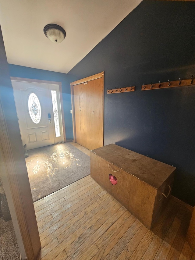 foyer featuring vaulted ceiling and hardwood / wood-style flooring