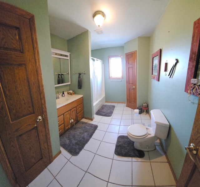 bathroom featuring tile patterned floors, toilet, curtained shower, and vanity