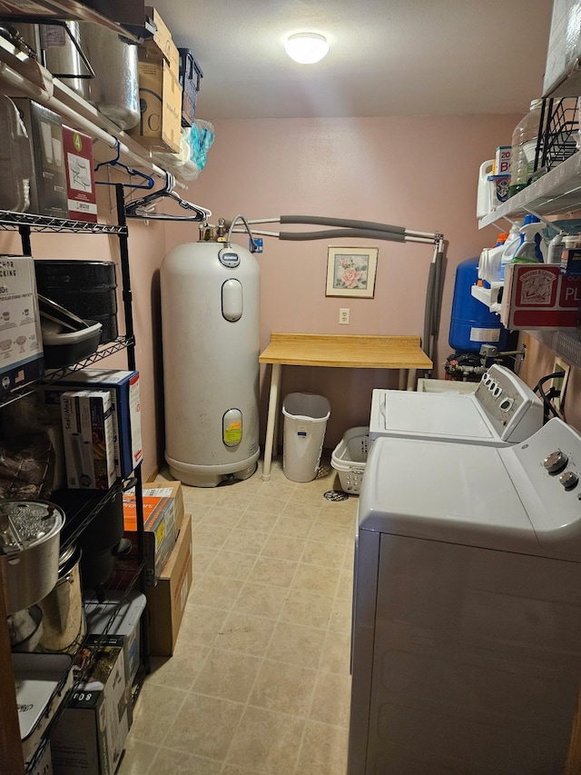 laundry area featuring water heater, washer and clothes dryer, and laundry area