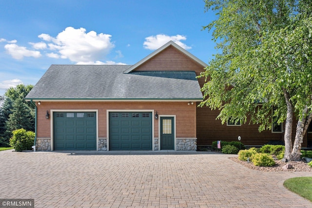 garage featuring decorative driveway