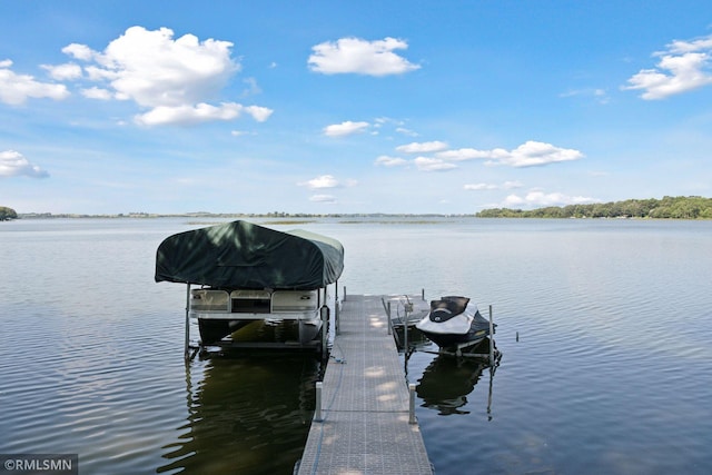 view of dock with boat lift and a water view