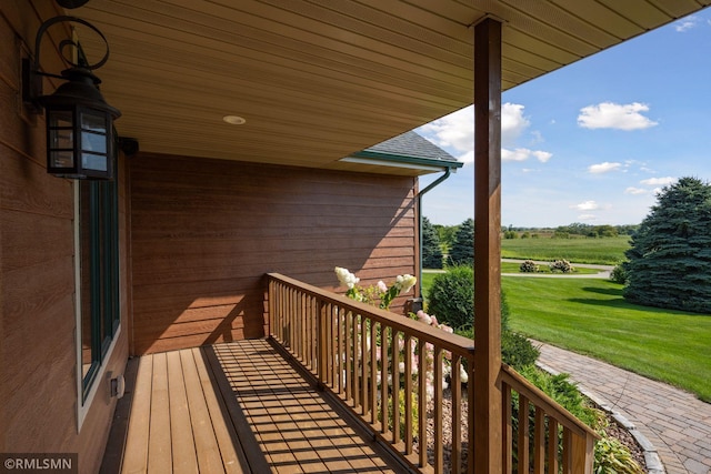 wooden deck with a lawn