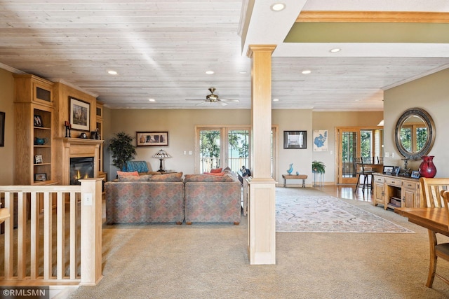 carpeted living room with plenty of natural light, wooden ceiling, and ornate columns