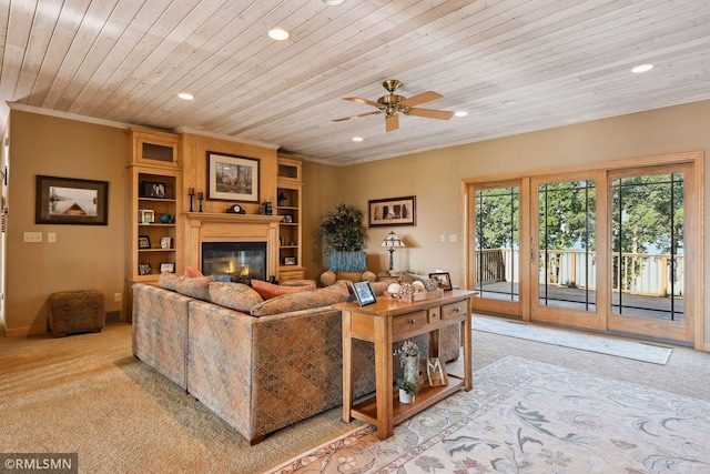 living room featuring wooden ceiling, a glass covered fireplace, light colored carpet, ornamental molding, and recessed lighting