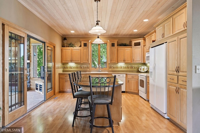kitchen featuring a breakfast bar area, white appliances, wooden ceiling, decorative backsplash, and a sink