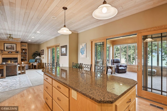 kitchen featuring open floor plan, wooden ceiling, crown molding, and visible vents