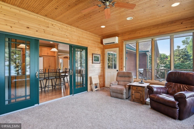 sitting room with wooden ceiling, an AC wall unit, carpet flooring, and a ceiling fan