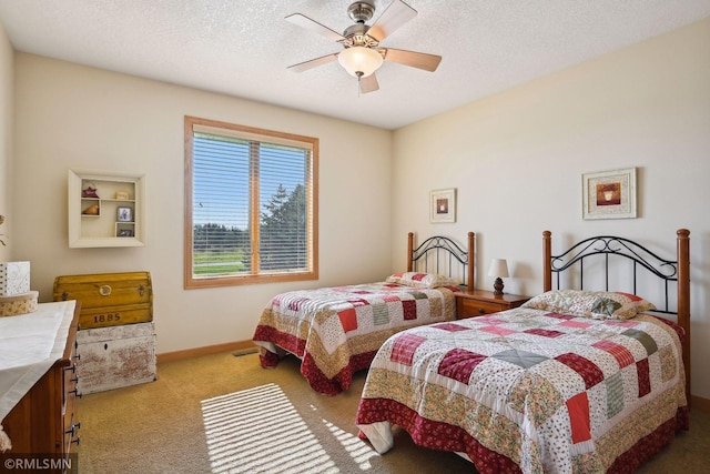 bedroom with baseboards, ceiling fan, carpet floors, and a textured ceiling