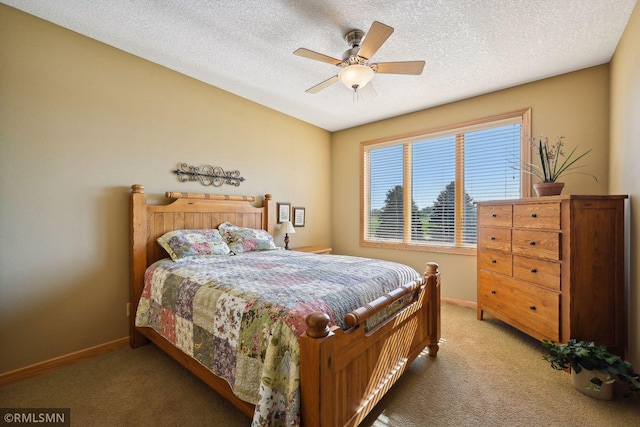 bedroom featuring baseboards, a textured ceiling, ceiling fan, and light colored carpet