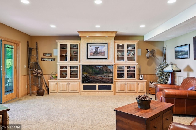 living area featuring carpet flooring, recessed lighting, and wainscoting