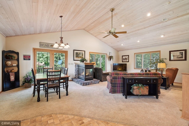 living room featuring vaulted ceiling, wood ceiling, carpet flooring, and a healthy amount of sunlight