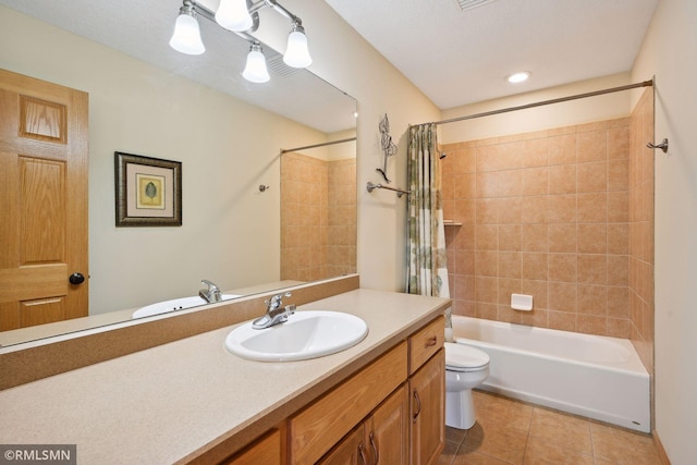 bathroom featuring tile patterned floors, toilet, vanity, and shower / bath combo with shower curtain
