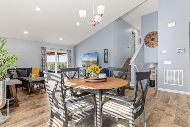 10120 189th Ave NW, Elk River, MN 55330 - dining space featuring light wood-type flooring, recessed lighting, stairway, a chandelier, and lofted ceiling