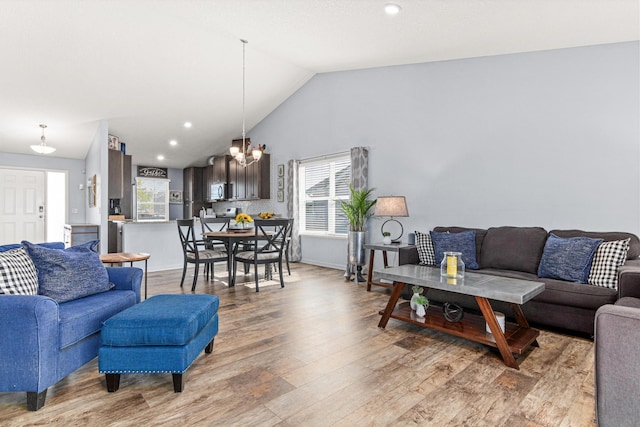 10120 189th Ave NW, Elk River, MN 55330 - living area featuring light wood finished floors, vaulted ceiling, a chandelier, baseboards, and recessed lighting