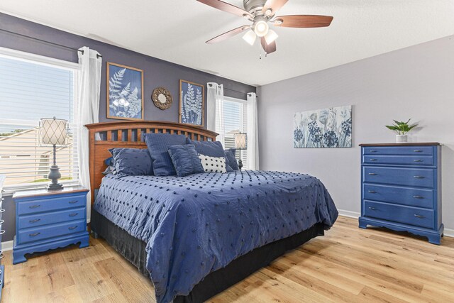 10120 189th Ave NW, Elk River, MN 55330 - bedroom featuring light wood finished floors, a ceiling fan, and baseboards