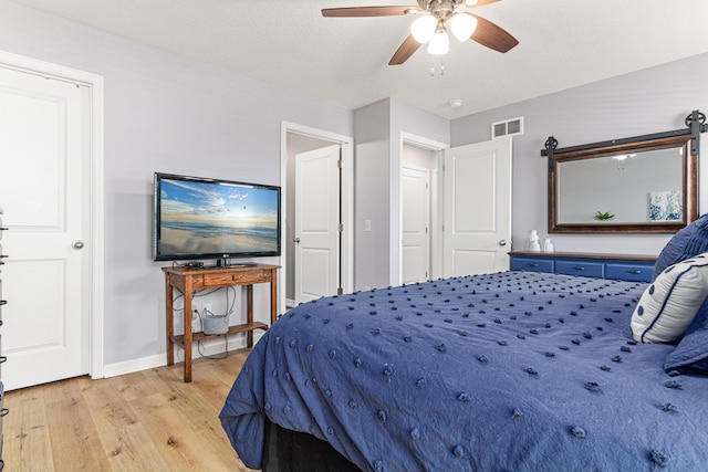 10120 189th Ave NW, Elk River, MN 55330 - bedroom with light wood-type flooring, baseboards, and ceiling fan