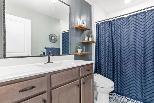 10120 189th Ave NW, Elk River, MN 55330 - bathroom with toilet, vanity, and a shower with shower curtain