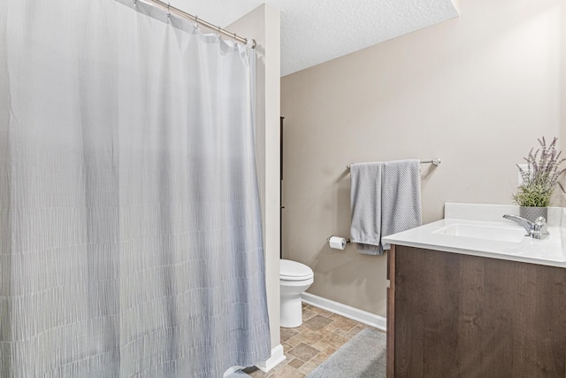 10120 189th Ave NW, Elk River, MN 55330 - bathroom with toilet, stone tile flooring, vanity, baseboards, and a shower with shower curtain