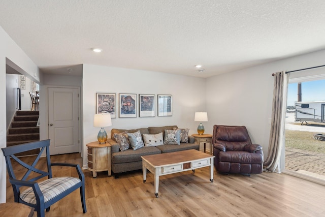 10120 189th Ave NW, Elk River, MN 55330 - living area with light wood-type flooring, a textured ceiling, recessed lighting, and stairway