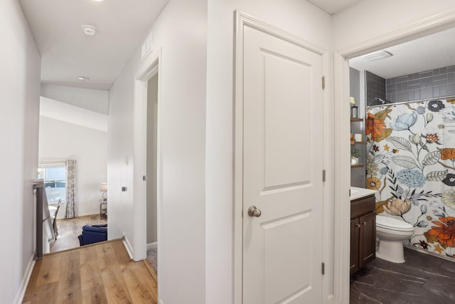 10120 189th Ave NW, Elk River, MN 55330 - full bath with vanity, toilet, a shower with shower curtain, baseboards, and wood finished floors