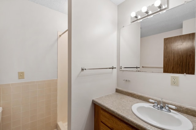 450 Ford Rd Unit 225, Saint Louis Park, MN 55426 - full bath with vanity, a shower, and a textured ceiling