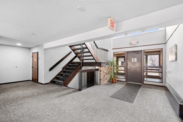 450 Ford Rd Unit 225, Saint Louis Park, MN 55426 - entryway featuring a textured ceiling, carpet, and stairway