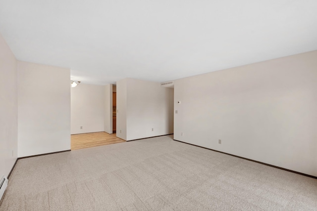 450 Ford Rd Unit 225, Saint Louis Park, MN 55426 - spare room featuring light colored carpet and a baseboard heating unit