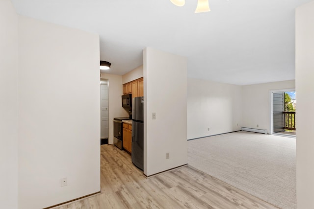 450 Ford Rd Unit 225, Saint Louis Park, MN 55426 - empty room with baseboard heating and light wood-style flooring