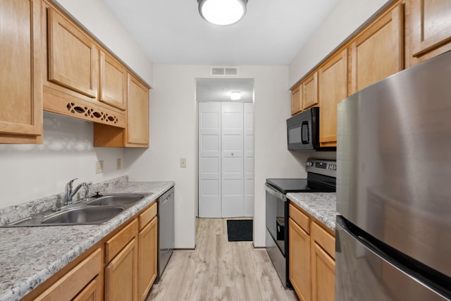 450 Ford Rd Unit 225, Saint Louis Park, MN 55426 - kitchen with appliances with stainless steel finishes, light wood-style flooring, light countertops, and light brown cabinets