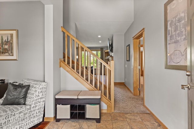 entryway featuring baseboards, stairs, and recessed lighting