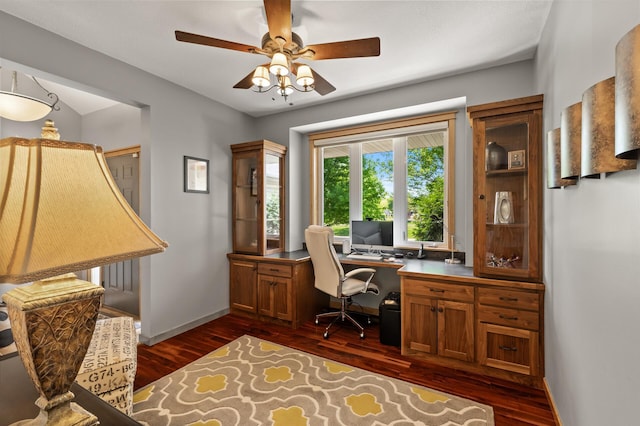 office space with dark wood-style floors, baseboards, and ceiling fan