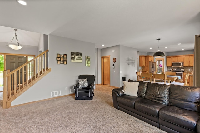 living area featuring light carpet, recessed lighting, baseboards, and stairway