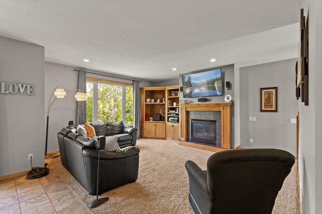 carpeted living area featuring a premium fireplace, recessed lighting, and baseboards