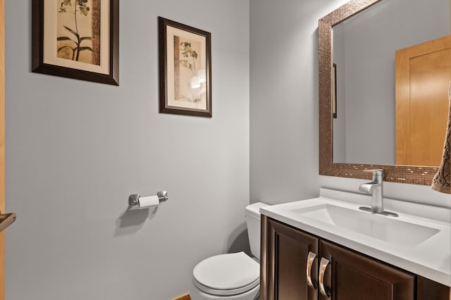 half bath featuring toilet and vanity