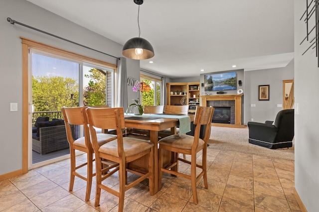 dining space with a tiled fireplace, baseboards, and recessed lighting
