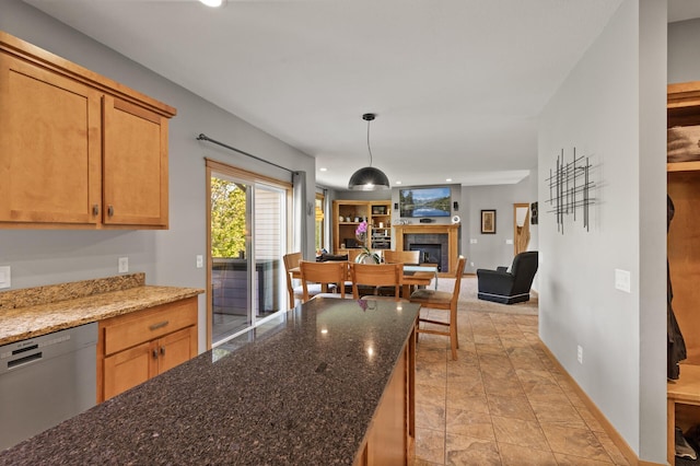 kitchen with stainless steel dishwasher, recessed lighting, a fireplace, open floor plan, and baseboards