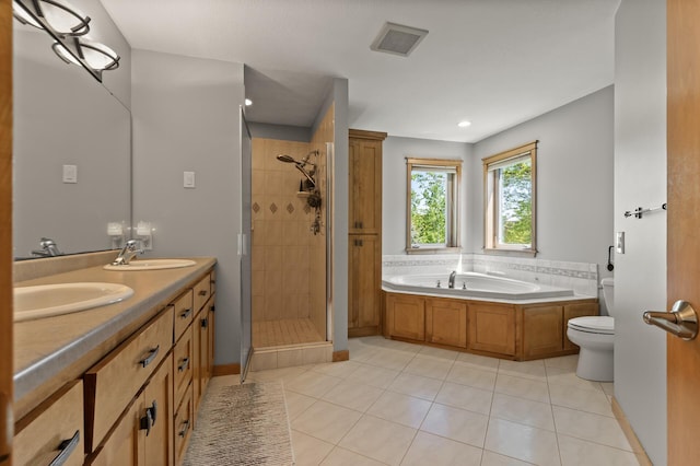 bathroom featuring tile patterned flooring, a stall shower, a garden tub, toilet, and recessed lighting