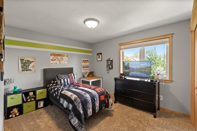 carpeted bedroom with a textured ceiling