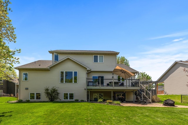 back of house with stairs, a wooden deck, and a lawn