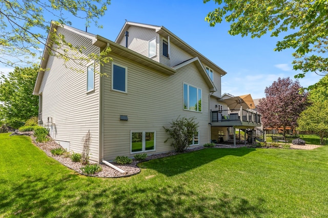 back of property with a wooden deck, stairs, and a yard