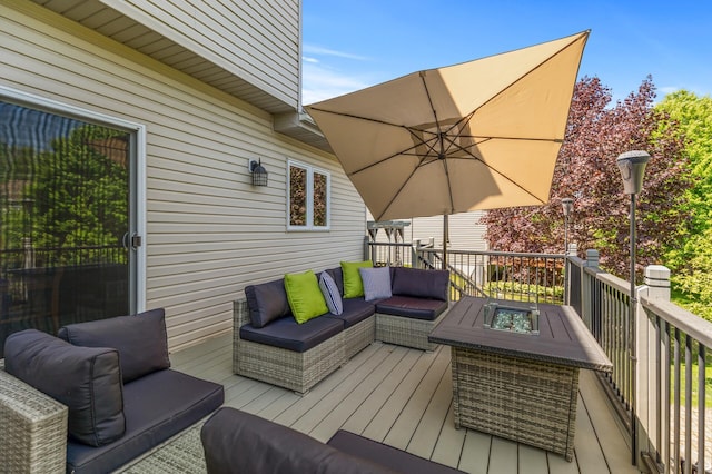 wooden terrace featuring an outdoor living space with a fire pit