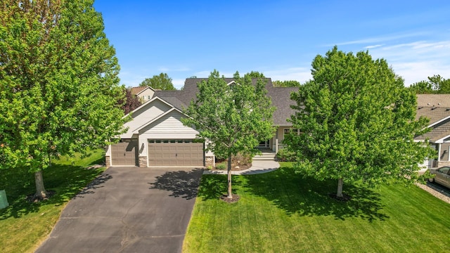 obstructed view of property with driveway, a front lawn, a garage, and roof with shingles