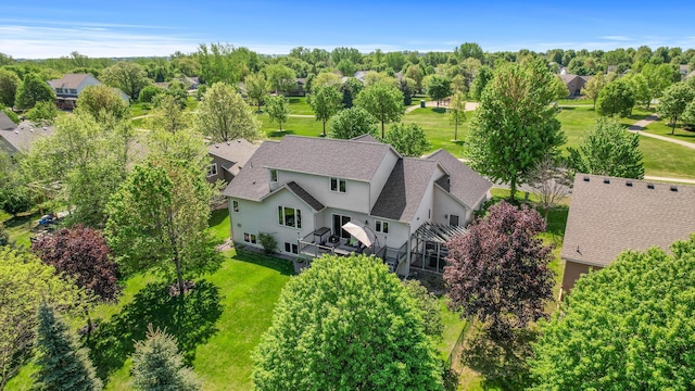 aerial view of property and surrounding area with a tree filled landscape