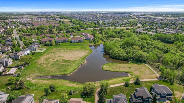 aerial view of property and surrounding area featuring a large body of water and nearby suburban area