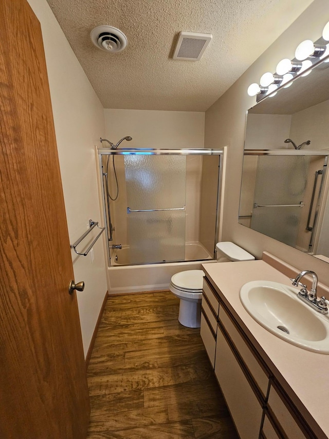21965 Shady Walk Unit 201, Deerwood, MN 56444 - full bath with toilet, visible vents, wood finished floors, and a textured ceiling