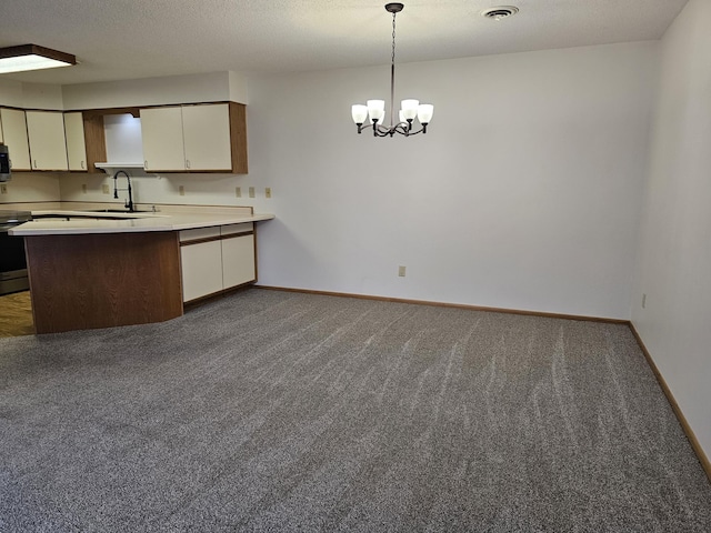 21965 Shady Walk Unit 201, Deerwood, MN 56444 - kitchen featuring light countertops, baseboards, a sink, visible vents, and a peninsula